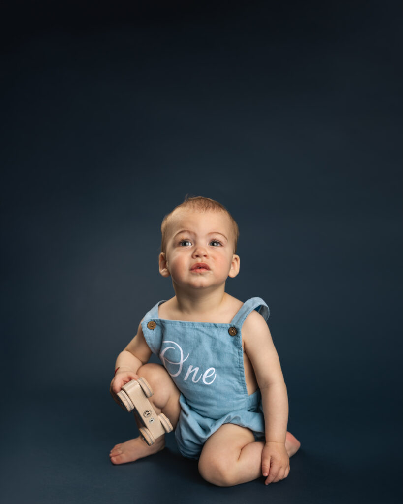 personality portrait of a young boy in a monochromatic bluye studio set