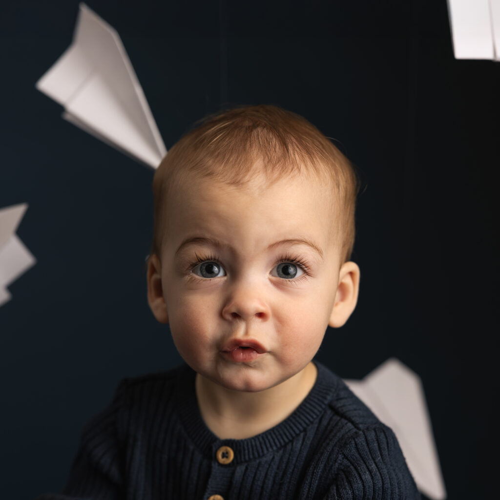 young boy looking at camera with big blue eyes