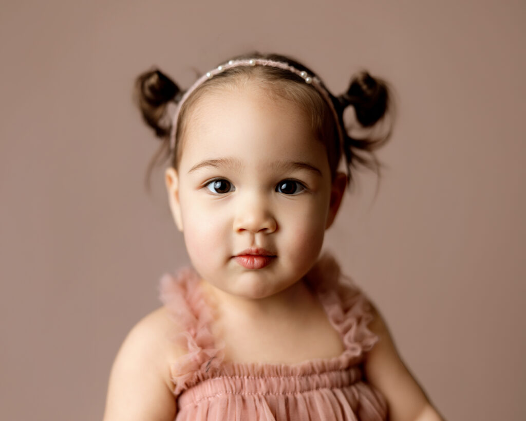 sweet image of a young girl wearing pink to match her studio photography colors